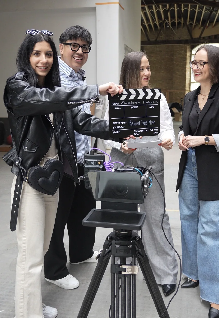 The Khodakovska production team behind the camera with a clapperboard