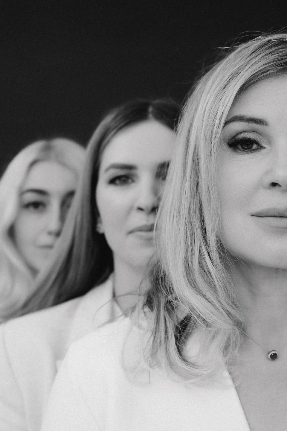 Black-and-white close-up group portrait in a studio