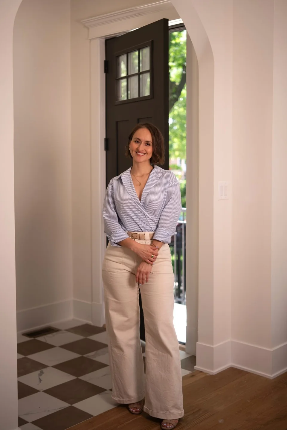 Professional portrait beside an arched doorway and patterned floor