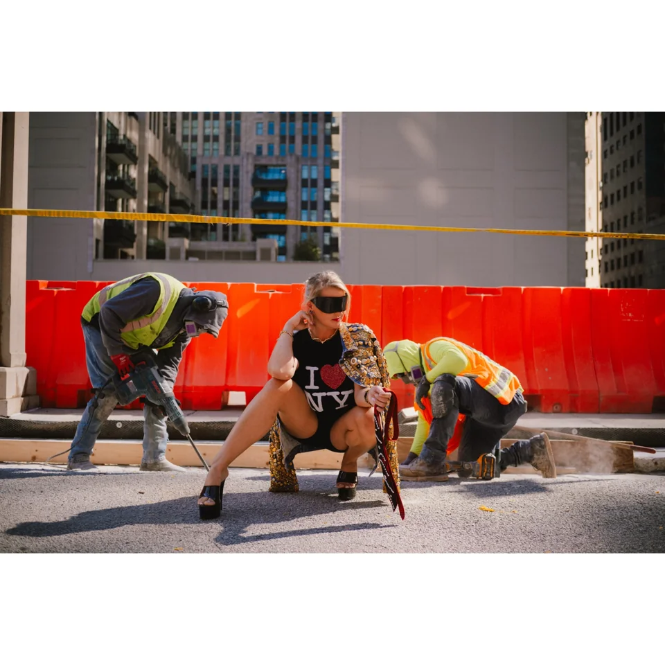 Urban fashion campaign with construction workers and red barriers