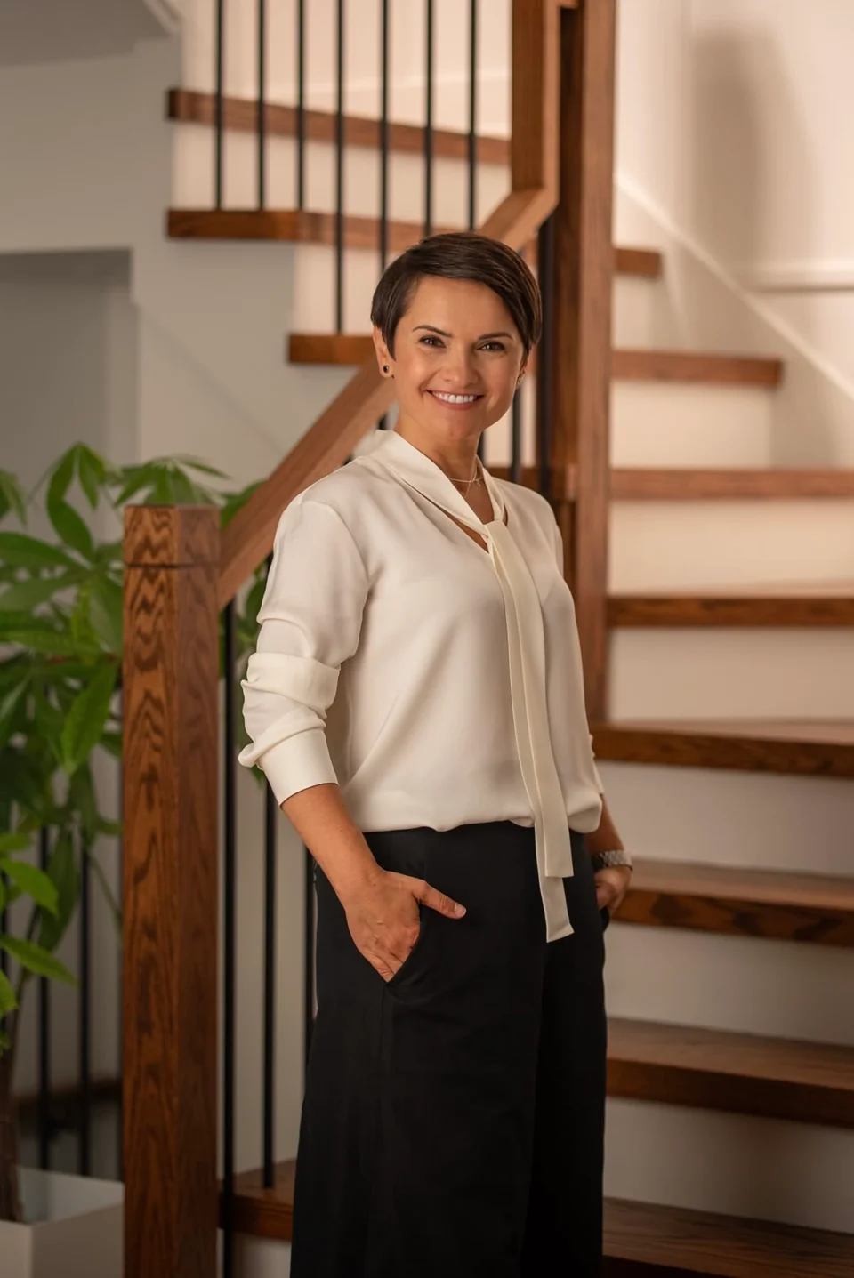 Business portrait in a warm interior beside a staircase
